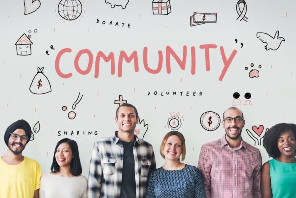 a group of people standing under the word Community