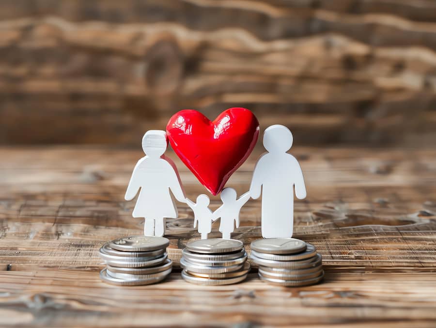 An outline of a family with a red heart and coins